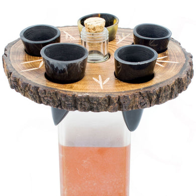 Wooden drink holder with four small cups and a cork on a white background