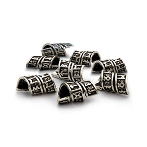 Silver beads with intricate designs on a white background for beard and hair earrings